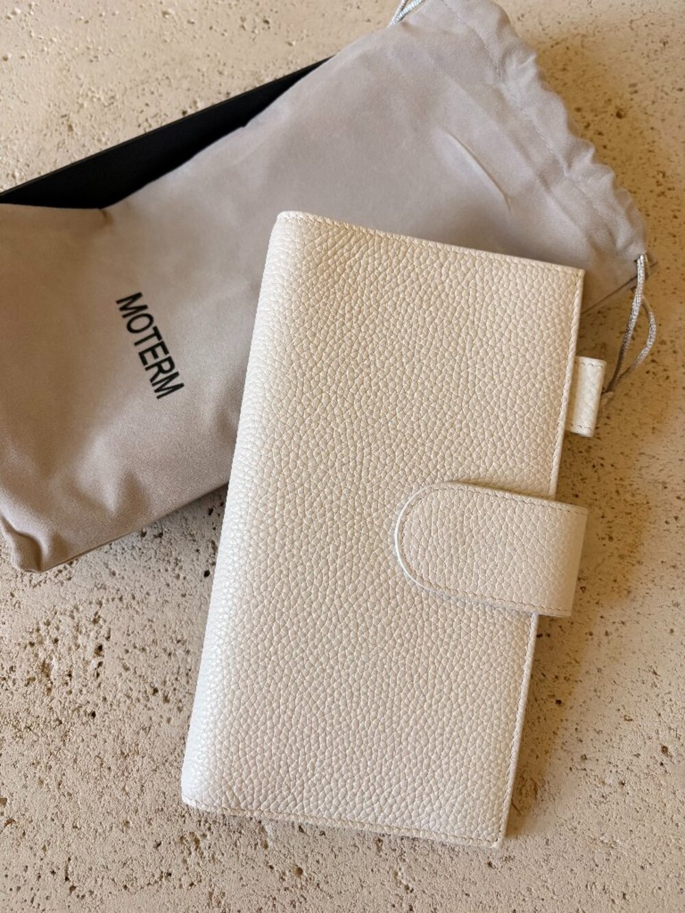 Never used Moterm weeks in white pebbled leather